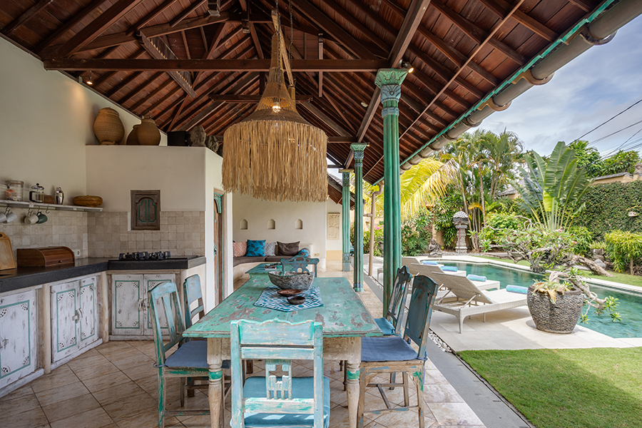 The central building features the open lounge living area, dining table and fully equipped kitchen.